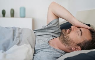 Man waking up early with headache