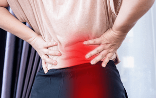 woman suffering from lower back pain and sciatica
